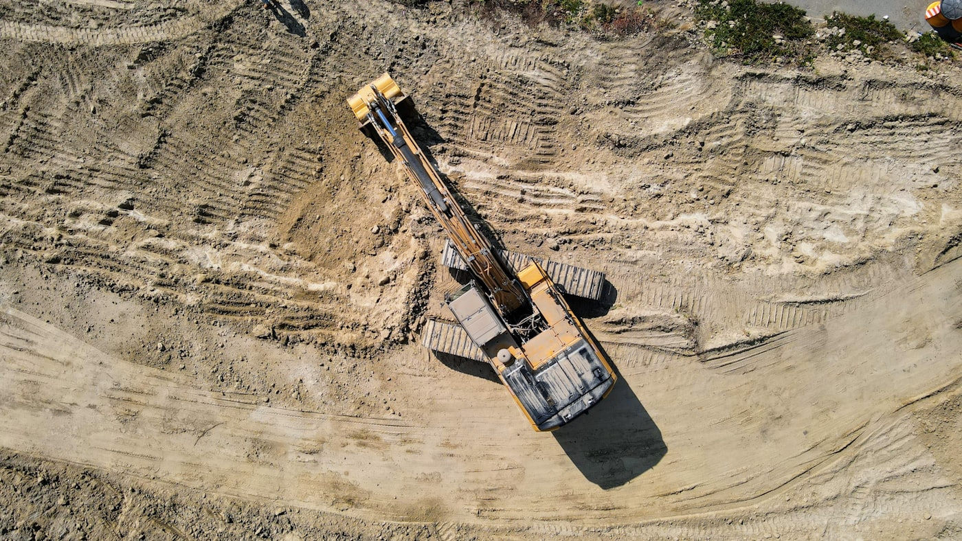 Heavy tracked equipment working through broken rock and rubble
